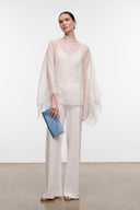 Ivory high-neck top with sheer cape sleeves and relaxed straight hem