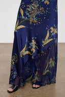 Silk halter dress in dark blue with gold botanical tapestry print, draped skirt