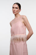 Pink sleeveless sheer camisole top with feather fringe waistband and round neck