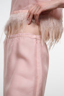 Light pink satin skirt with feather fringe hem and center-front seam