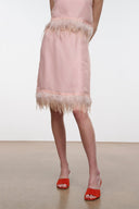 Light pink satin skirt with feather fringe hem, mid-thigh length