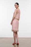 Light pink satin midi skirt with feather fringe hem, side view