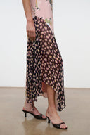 Pink floral maxi dress with sheer black side overlay and asymmetrical hem.