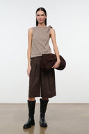 Dark brown knee-length shorts with elastic waist and loose wide fit