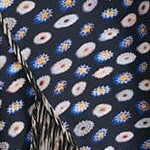 Silk skirt with navy base and multicolor dot pattern, asymmetric tiered hem