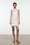 Ivory sleeveless mini dress with high neckline and feather fringe hem