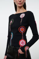 Black long-sleeve top with multicolor circular embroidery and tassels, round neckline