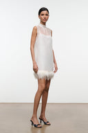 Ivory sleeveless mini dress with high neck and feather trim at the hem