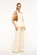 Dark gray hobo shoulder bag with metal strap hardware, carried on shoulder