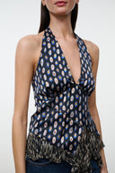 MAEVA silk halter top close-up: navy multicolor print, keyhole front, fringe trim