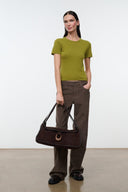 Espresso brown messenger bag with top flap and crossbody strap, worn at front.
