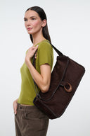 Espresso brown suede messenger bag with flap detail and rounded ring pull.