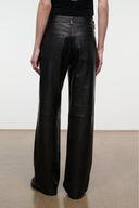 Black leather trousers with wide straight legs, belt loops, and back yoke seam