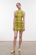 Butter yellow slip-on flats with gathered front, worn with plaid mini dress