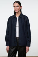 Indigo denim shirt jacket with button-up front, pointed collar, and chest welt pockets