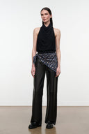Black leather trousers with wide legs, front pockets, and subtle stitched paneling