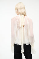 Ivory sheer backless top with tie-back keyhole and long flowing sleeves