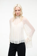 Ivory sheer high-neck top with long balloon sleeves and gathered cuffs