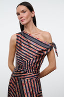 One-shoulder silk dress close-up, black rust and cream geometric print, tied shoulder