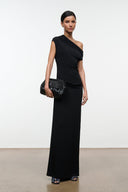 Black convertible shoulder bag with flap and small front logo, carried across the body