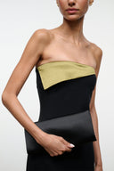 Black satin clutch with olive front panel, held in front