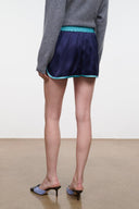 Dark navy sleep shorts with teal elastic waistband and turquoise piping, side view