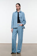 Sky-blue suede shirt with point collar and black buttons; relaxed fit, long sleeves