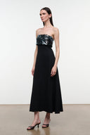 Black strapless midi dress with sparkling sequined corset-style bodice and flowing skirt