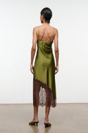 Pear green silk slip dress back view with spaghetti straps and brown lace hem