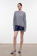 Ash gray cashmere crewneck sweater with embroidered dog crest; ribbed cuffs and hem