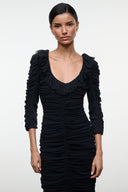 Black ruched midi dress with sweetheart neckline and long gathered sleeves.