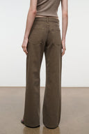 Relaxed dark olive jeans front view, visible seams and relaxed wide leg