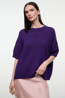 Purple cashmere sweater with crew neck and short sleeves, relaxed drape, front view.