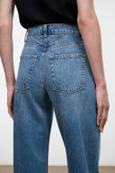 High-rise blue denim jeans with back yoke and two rear patch pockets.
