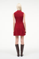 Red sleeveless sweater dress, back view, diamond cable-knit pattern