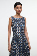 Sleeveless navy midi dress with abstract yellow-dot print, round neckline and fitted bodice