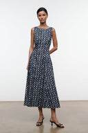 Sleeveless navy midi dress with abstract yellow-dot print, round neckline and pleated skirt