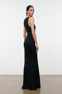 Black sleeveless maxi dress, scoop neck and thin straps, side view with flared hem