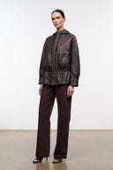 Dark brown leather jacket with hood, front zipper and cinched drawstring waist, long sleeves