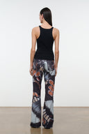 Back view flare jeans with black waistband and abstract butterfly print, wide-leg drape