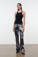 Front view flare jeans with abstract butterfly print, wide flared hems and dark base