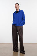 Dark oak wide-leg pants with elastic waistband and loose drape, full length