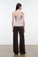 Back view of women's champagne sleeveless top with open scoop back and tied strap