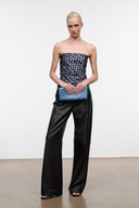 Light blue satin clutch bag with fold-over top, held at waist