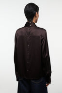 Back view of earth-brown silk top with stand collar and button placket