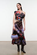 Knee-high dark espresso snake-embossed boot with low heel, worn with a dress.