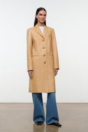 Tan leather single-breasted long coat with notched lapels and button closure.