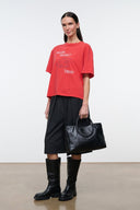 Relaxed red T-shirt with front graphic text 'FEELING PRICKLY' and 'TODAY', side view