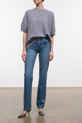 Straight-leg blue denim jeans with vintage wash, belt loops, and zip fly