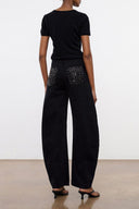 Black barrel jeans with studded back pockets and wide leg